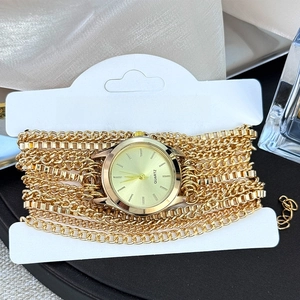 Detail of elegant gold layered chain strap women's watch with quartz movement dial