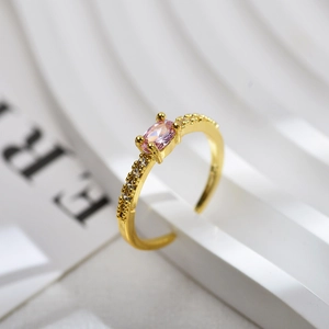 Detail view of gold-plated open ring featuring a pink oval zircon and side micro-pave stones
