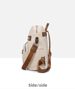 Side view of beige soft leather backpack with metal zippers and brown fabric straps