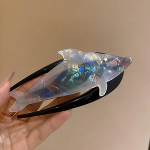 Detailed close-up of whale-shaped hair claw clip with holographic aurora finish