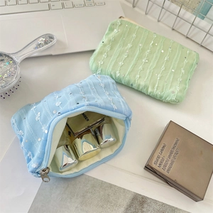Detail of sequined lace chiffon flower pouch with zipper closure for makeup storage