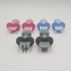 Baby training spoon and fork set in pink, blue, and gray silicone with safety guards