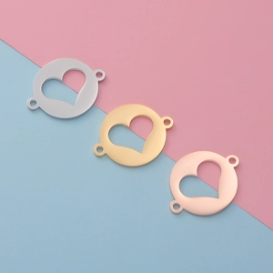 Polished heart hollow charms in silver, gold, and rose gold finishes on dual-tone background