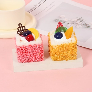 Set of two realistic PU mini mousse cakes with assorted fruit toppings and display props