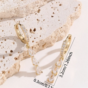 Elegant gold drop earrings with triple water drop zircons on a textured stone base