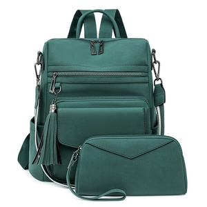 Detail of dark green two-piece backpack set with fringe tassel and striped strap