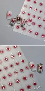 Macro detail of M-884 gothic nail art stickers featuring burgundy smudge and silver hearts