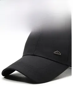 Close-up of a black cotton baseball cap with a silver metal mountain logo on the side