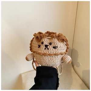 Close-up of handmade crochet lion bucket bag showing detailed brown mane and embroidery