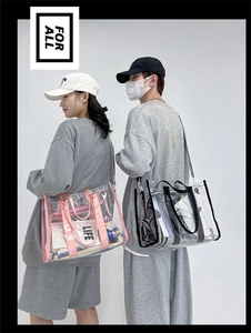 Detailed view of clear PVC tote bags in pink and black with woven handles and straps