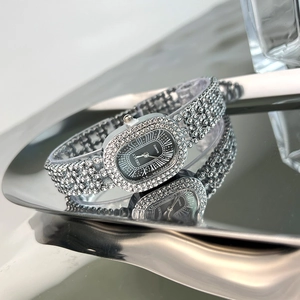 Detail of silver ladies' quartz watch with sparkling rhinestones on an oval dial