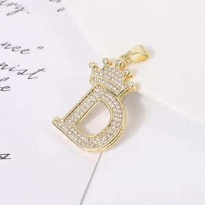 Gold-plated crown letter D pendant necklace with sparkling cubic zirconia on white background