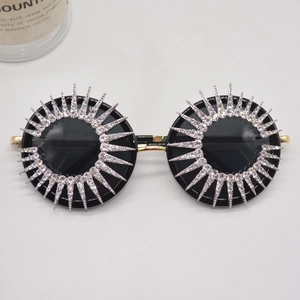 Sparkling crystal sunburst round sunglasses with gold metal frame and black lenses