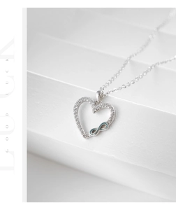 Macro view of S925 silver heart necklace with infinity symbol and blue enamel details