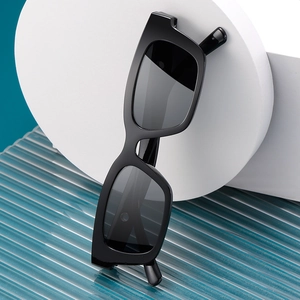 Classic black oversized square sunglasses with a glossy frame and dark lenses for women
