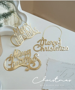 Three-piece set of shiny golden Merry Christmas metal ornaments for holiday tree decoration