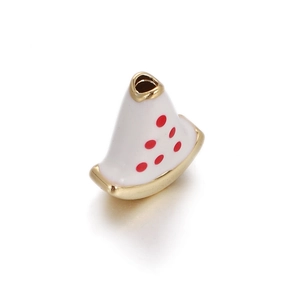 Detailed view of a white enamel bead with red dots and gold plating for DIY jewelry
