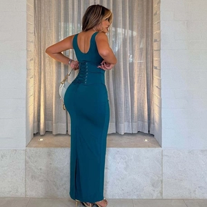 Detailed back view of a slim dark green maxi dress featuring a chic lace-up waist design