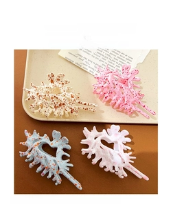Detail view of resin coral hair claws with colorful splatter patterns in four styles