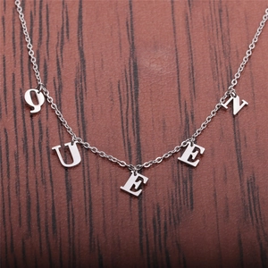 Polished stainless steel chain necklace with Queen letter pendant on wooden background