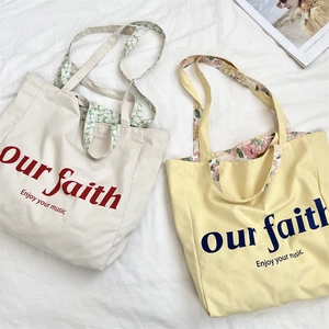Detailed view of floral lining and printed typography on large canvas tote bags