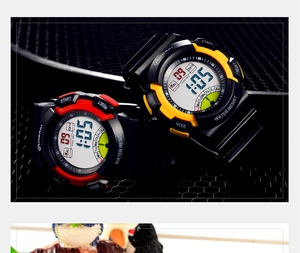 Detail of waterproof digital sports watches with red and yellow bezels on black rubber straps