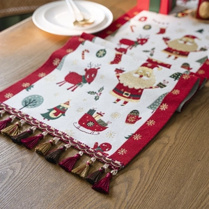 Christmas jacquard table runner with Santa patterns, red fringe, and festive tassels