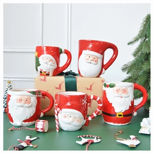 Macro detail of various 3D Santa Claus ceramic mugs arranged on a green table