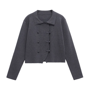 Detail view of dark grey knit cardigan with asymmetric buttons and a classic polo collar