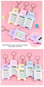 Detail view of mini cartoon bear calculator with quiet buttons and keychain attachment