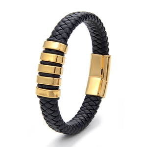 Detail of woven black leather bracelet with five gold metal beads and magnetic clasp