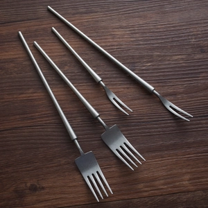 Retro 304 stainless steel fork set with matte silver-gray finish on dark wood background