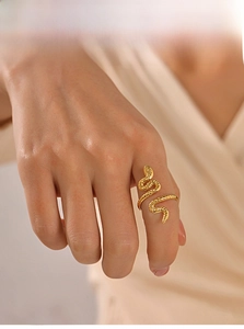 Detailed view of 18k gold snake ring with spiral scales and adjustable open design