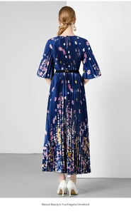 Detail van de marineblauwe plisséjurk met bloemenprint en fijne accordeonplooien