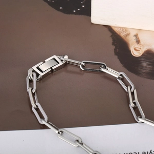 Detailed shot of silver stainless steel paperclip chain bracelet with square clasp
