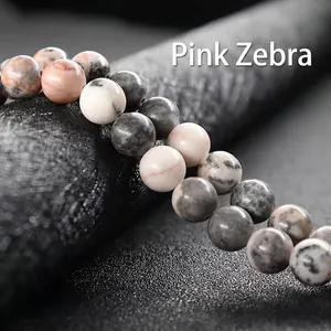 Macro shot of polished round pink zebra stones with unique natural pink and grey patterns