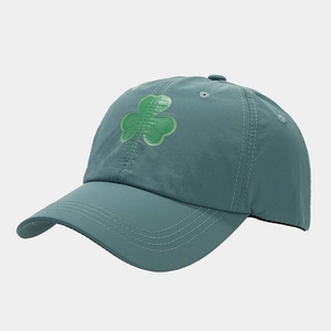 Detailed view of teal quick-dry baseball cap with reflective green shamrock print