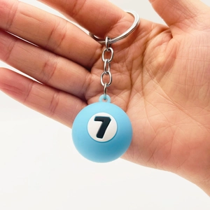 Close-up of number 7 blue billiard ball keychain with durable metal chain and ring