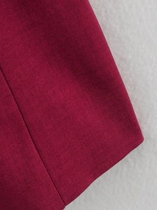Close-up of burgundy plaid fabric texture with fine weave details on a soft background