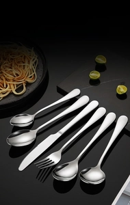 Polished 304 stainless steel cutlery set featuring knives and spoons on dark marble