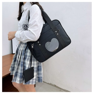 Detail of black JK uniform travel bag featuring a clear heart-shaped display window