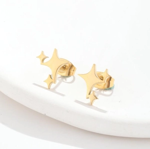 Macro detail of high-quality gold-plated star stud earrings with geometric starburst design
