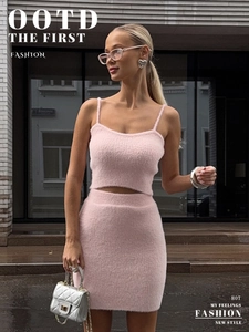 Detail of pink fuzzy knit crop top and high waist skirt showing soft plush texture