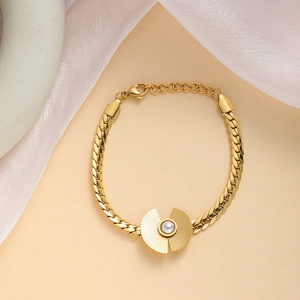 Detailed view of gold plated titanium bracelet with central pearl and lobster clasp