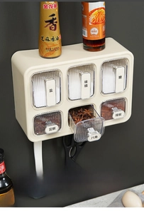 Detail view of wall-mounted kitchen spice box with six transparent drawers for seasoning storage