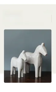 Detailed close-up showing the artistic faux wood texture on Nordic horse statues