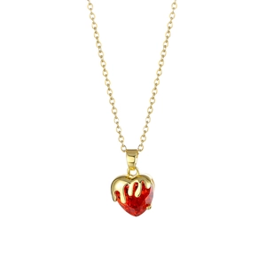 Gold heart necklace featuring a faceted red crystal pendant with a unique melting gold design