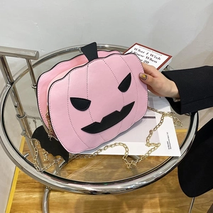 Pink pumpkin shaped crossbody bag with gold chain and bat pendant for Halloween