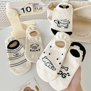 Cute cartoon puppy patterned low-cut cotton socks for women in beige lifestyle setting