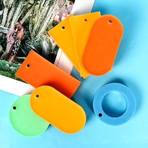 DIY colorful acrylic pendant set with various shapes on blue background for crafts
